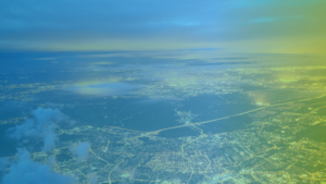 Large image of a cityscape with a gradient of blue to green overlaid